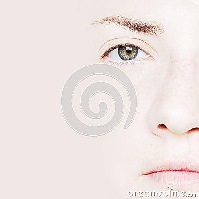 Closeup Portrait of Woman with Green Eyes Showing Half Face. Stock Photo