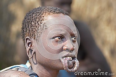 A closeup shot of a young African male with traditional body modifications from the Mursi Tribe Editorial Stock Photo