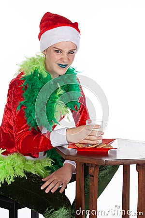 Closeup portrait of young girl wearing red santa clause hat sneering to camera Stock Photo