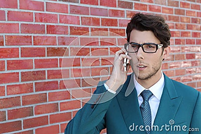 Closeup portrait, young man annoyed, frustrated, off by someone listening on his mobile phone, bad news, outdoors Stock Photo