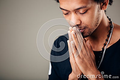 Praying african american man hoping for better. Asking God for good luck Stock Photo