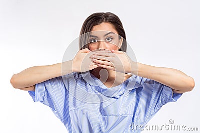 Closeup portrait of a young woman covering her mouth with her both hands. No freedom of speech, silence, concealment concept Stock Photo