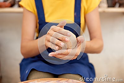 closeup of potter with wet clay pot in hands. pottery hobby woman hands sculpt in clay Stock Photo
