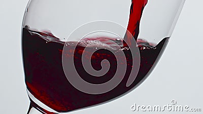 Closeup pouring red wine glass indoors. Alcoholic liquid filling wineglass Stock Photo