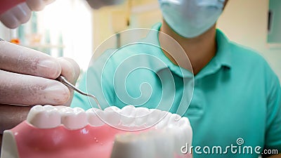 Closeup POV image of dentist using special dental instruments for inspecting teeth Stock Photo
