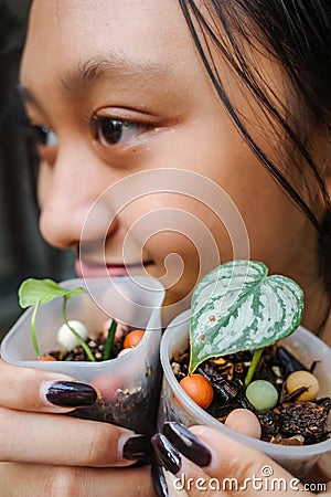 Pretty Asian Teen Girl Holding Baby Tropical Plants Stock Photo