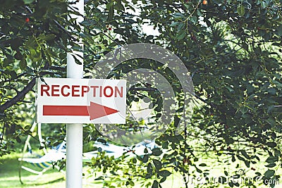 Closeup reception sign on front office hotel. Stock Photo