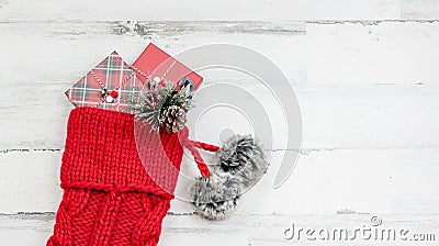 Closeup of red knit Christmas stocking on white wood background Stock Photo