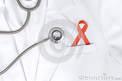 Red ribbon inserted to the pocket of lab coat Stock Photo