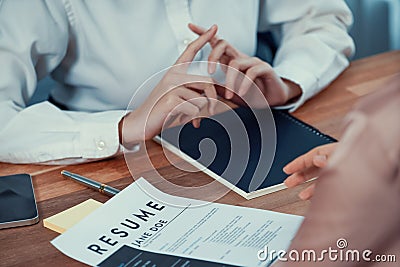 Closeup resume paper with qualifications on desk during interview. Enthusiastic Stock Photo