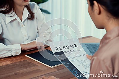 Closeup resume paper with qualifications on desk during interview. Enthusiastic Stock Photo