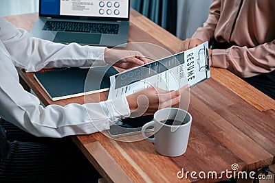 Closeup resume paper with qualifications on desk during interview. Enthusiastic Stock Photo