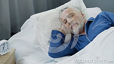 Closeup of retired man sleeping in bed in the morning, recovery time, health Stock Photo