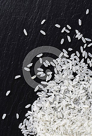 Closeup rice on black stone background Stock Photo
