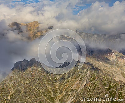 rocky mountain chain in dense clouds Stock Photo