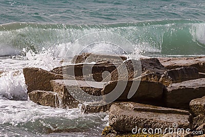 closeup rocky sea cape among splashing waves Stock Photo