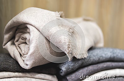Closeup rolled beige cashmere woollen blanket Stock Photo