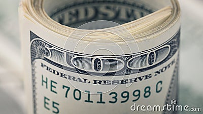 Closeup rolled dollar hundred on background American money dollar bill. Many US 100 banknote Stock Photo