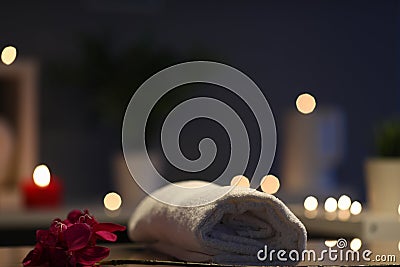 Closeup rolled terry towel and flower, salon decor Stock Photo