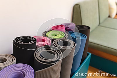 Closeup of rolled up colorful exercise mats in yoga studio Stock Photo