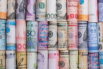 Closeup rolled of variety banknote and multi currency around the world. Exchange rate and Forex investment concept.-Image Stock Photo