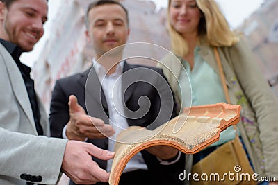 Closeup roof tile held by rep Stock Photo