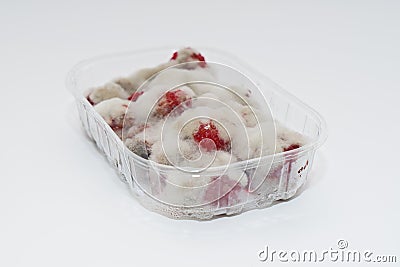 Closeup of rotten moldy raspberry in plastic box isolated on white background Stock Photo