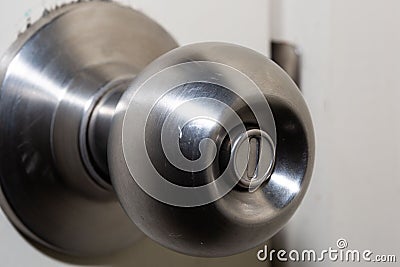 Closeup of a round door handle knob with push lock Stock Photo