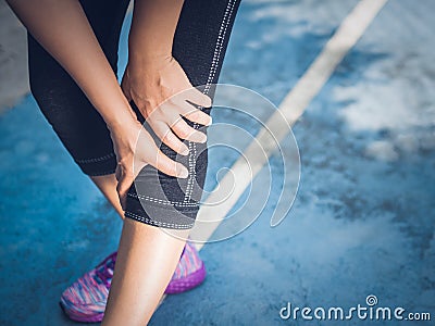 Closeup runner sport knee injury. Woman in pain while running. Stock Photo