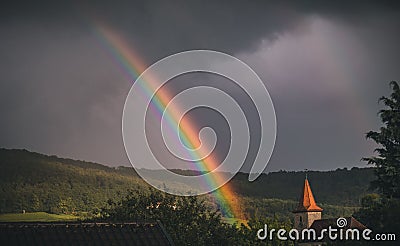 Closeup of rural German country with a beautiful rainbow during cloudy weather, Baden-Wurttemberg Stock Photo