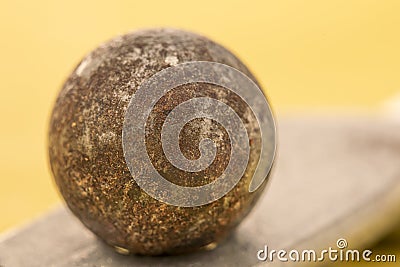 Closeup of a rusty ball bearing on a copper plate Stock Photo