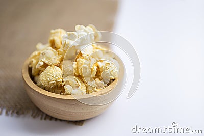 Closeup salted popcorn in round wooden bowl Stock Photo
