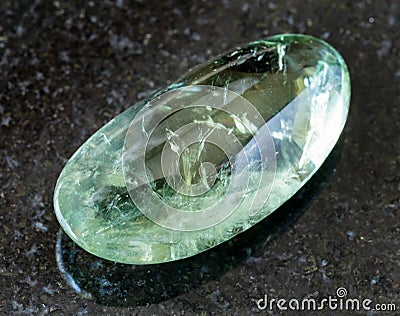 polished Prasiolite (green quartz) rock on black Stock Photo