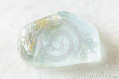 Tumbled blue Topaz rock on white marble Stock Photo