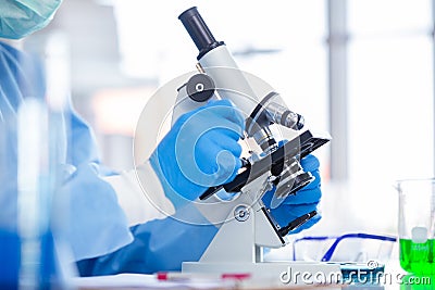 Closeup Scientist Doctor working in medical healthcare lab for medicine research looking at microscope. science covid virus Stock Photo
