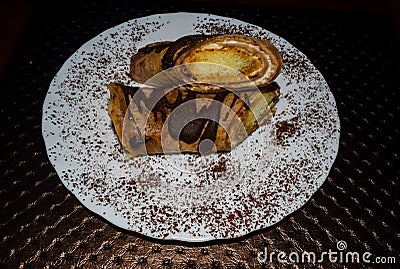 Closeup of sections of tiramisu pancakes with cocoa sprinkles Stock Photo