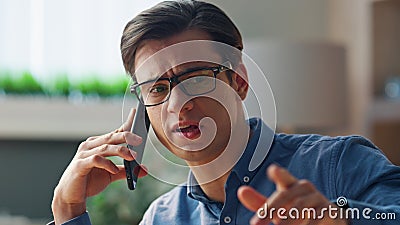 Closeup serious freelancer talking mobile phone office. Manager telephone call Stock Photo