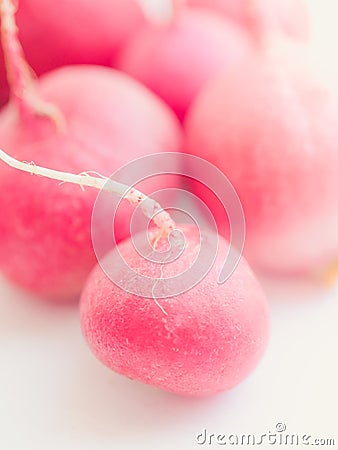 Closeup several ripe radishes on a white table Stock Photo