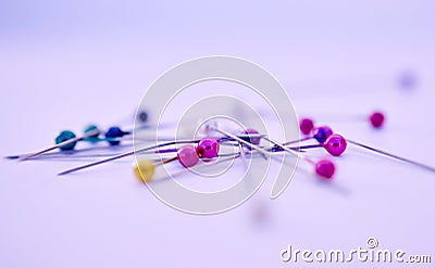 Closeup, sewing pin and design in studio by purple background for clothing manufacturing in factory. Macro, metal Stock Photo