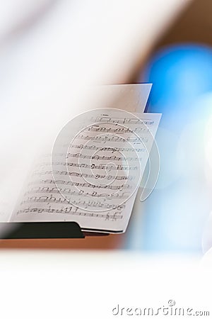 Closeup of sheet music in white bright background with colorful flares and selective focus Stock Photo