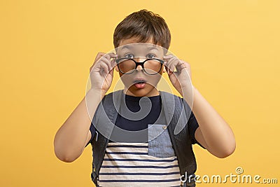 Closeup shocked scooler boy adjusting eyewear and looking at camera Stock Photo