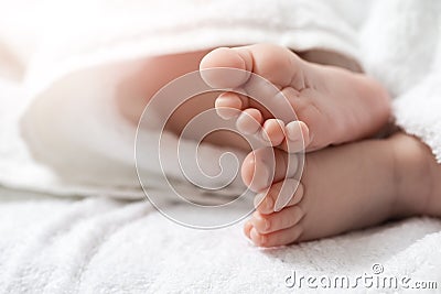 Closeup Shoot of a Four Week Old Baby Boy Feet Over Heap of White Towes Stock Photo