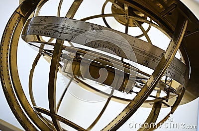 Closeup shot of an antique brass armillary sphere with zodiac signs Stock Photo