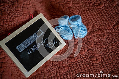 Closeup shot of a baby boy pregnancy announcement with cute shoes Stock Photo