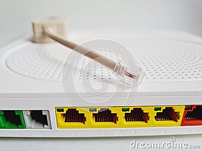 Closeup shot of a back of a modem router with colored network cable plugs Stock Photo