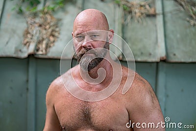 Closeup shot of a bald bearded man with no shirt Stock Photo