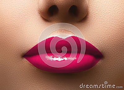 Closeup shot of beautiful full lips with magenta glossy make-up. Perfect bright pink lipstick. Plastic surgery Stock Photo