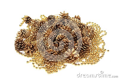 Closeup shot of beautiful golden pine cones and string beads isolated on white background Stock Photo