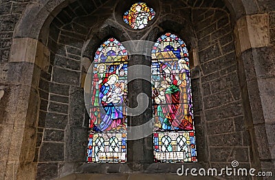 Closeup shot of the beautiful stained-glass windows of a catholic church Editorial Stock Photo