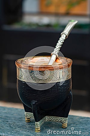 Closeup shot of a black mate cup with mate bombilla straw. Stock Photo